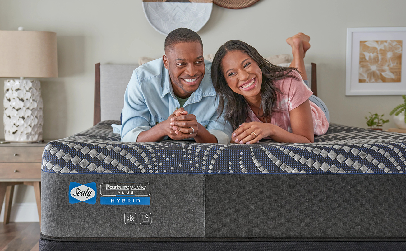 An image with a couple relaxing on their Tempur-Pedic mattress.